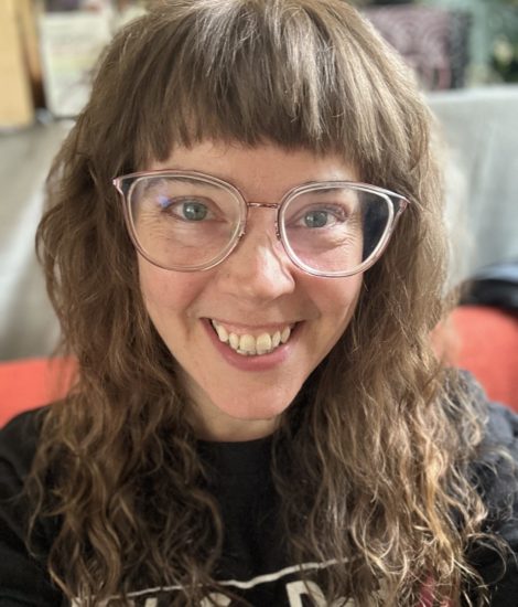 Woman wearing glasses with long hair.